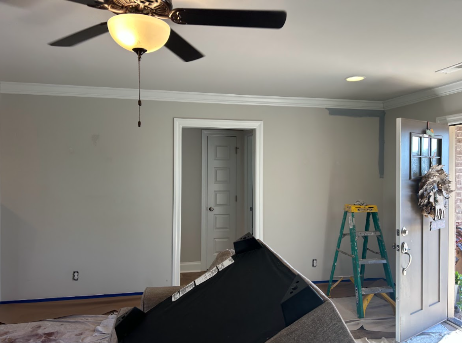 Interior painting in Huntsville showing covered floors and protected furniture